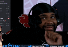 a man wearing headphones is smiling in front of a screen that says doshonstory 03