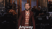 a man in a suit stands in front of an orchestra with the word anyway on the bottom