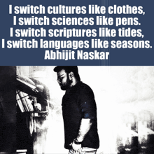 a man is standing in front of a sign that says ' i switch cultures like clothes ' on it