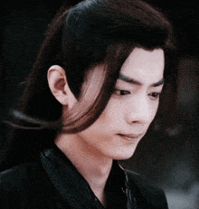 a close up of a man with long hair