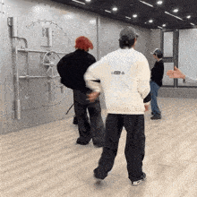 a man in a white jacket with the word supreme on the back is dancing