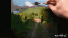 a person is painting a landscape with the words made in animotica below