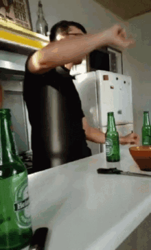 a bottle of heineken sits on a counter in a kitchen