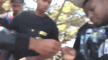 a blurry picture of a group of people with one man wearing a black shirt that says ' i 'm ' on it