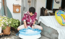 a man in a hawaiian shirt is sitting on a table with an inflatable raft