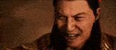 a close up of a man 's face with long hair making a funny face