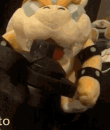 a close up of a stuffed animal with the word to in the bottom right corner
