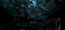 spider-man is flying through the air in a dark room .
