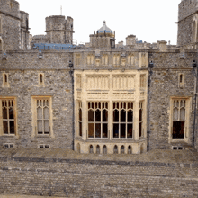 a castle with a large window and a tower in the background