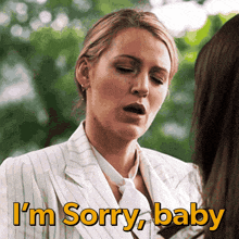 a woman in a suit says i 'm sorry baby to another woman