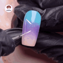 a person is painting a nail with a brush and a sticker that says nails inspiration
