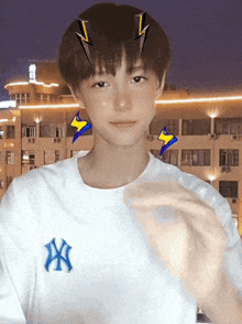 a young boy wearing a white shirt with the ny logo on it
