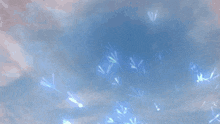 a dragon with blue wings is surrounded by flames and feathers