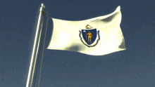 a white flag with a horseshoe and a man on it is waving in the wind