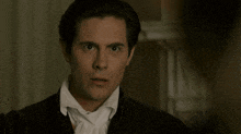 a man in a tuxedo says what are you suggesting while making a funny face