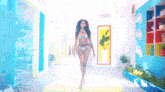 a woman in a bikini walking down a hallway