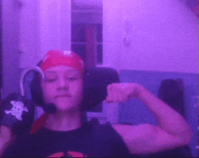 a boy wearing headphones and a bandana flexes his muscles in front of a purple background