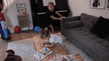 two children are playing on a couch in a living room with a sign that says " i wish everyone felt free " in the background