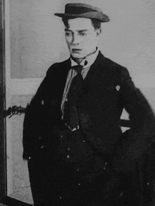 a black and white photo of a man with his hands in his pockets