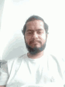 a man with a beard is giving the thumbs up sign