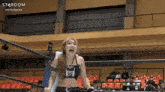 a woman in a wrestling ring with the words stardom on the bottom