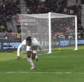a soccer player is running towards a goal that has a sign that says e ora disponi