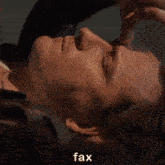 a man wearing a watch looks down with the word fax above his head