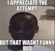 a black man with a bald head is wearing a white shirt and has a meme on his face .