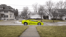 a yellow sports car is driving down a street