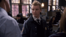 a man in a police uniform has a patch on his jacket that says nypd on it