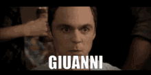 a close up of a man 's face with the name giovanni written on it