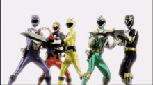 a group of power rangers are standing next to each other holding guns