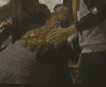 a woman is being held by a man in a gray shirt with a skull on the sleeve