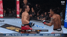 two men are fighting in a boxing ring and one of them is wearing a ufc shorts