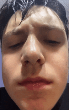 a close up of a person 's face with their eyes closed and their mouth open