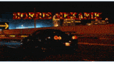 a black car is driving down a highway at night with the words morris mekanik written above it