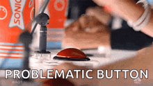 a person is pressing a button that says " problematic button " on it
