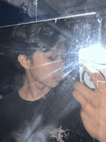 a person taking a picture of themselves in a mirror with a sticker that says ' s ' on it