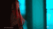 a close up of a woman 's face with the blacklist written on the bottom