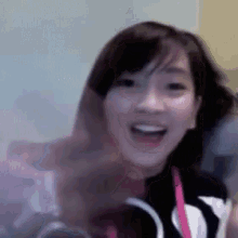 a young girl is smiling with her mouth open