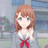 a girl with a flower in her hair is wearing a sailor uniform