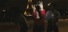 the eiffel tower is lit up in the background of this video