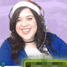 a woman wearing a santa hat and headphones is smiling
