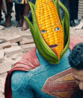 a man in a superman costume has a corn on the cob on his head