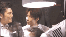 a group of men are standing next to each other in a room .