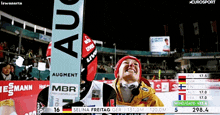 a woman stands in front of a banner that says augment on it