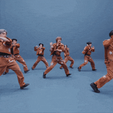 a man wearing a brown jacket with a star on the sleeve is dancing
