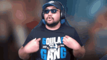 a man wearing a shirt that says goulas gang