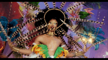 a woman in a colorful costume with feathers and flowers on her head