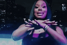 a woman with long black hair is making a funny face with her hands in the air